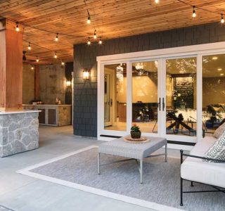 A home’s back patio with patio furniture and large fiberglass patio doors