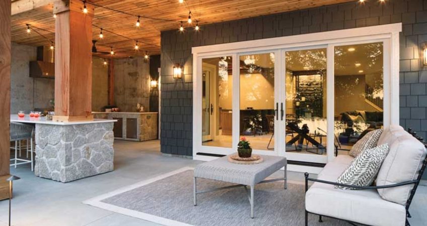 A home’s back patio with patio furniture and large fiberglass patio doors